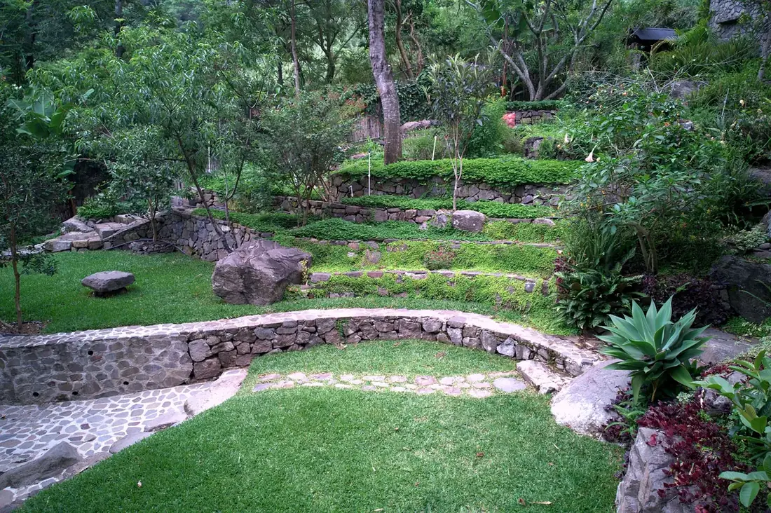 Finished curved stone terraces and lawn at Granja Tz'ikin